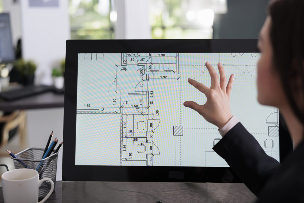 Real estate studio employee working in room floor planner